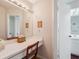 Bathroom vanity featuring a large mirror, ample counter space, and natural light at 7414 Heather Walk Dr, Weeki Wachee, FL 34613