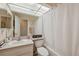 Bathroom with a vanity, toilet, shower-tub combo, and a large mirror at 7414 Heather Walk Dr, Weeki Wachee, FL 34613
