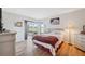 Comfortable bedroom with wood floors, natural light, and a sliding glass door at 7414 Heather Walk Dr, Weeki Wachee, FL 34613