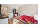Comfortable bedroom with closet, reading chair and wood-look floors at 7414 Heather Walk Dr, Weeki Wachee, FL 34613