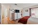 Bright bedroom with wood floors, plush bed and access to the enclosed outdoor patio at 7414 Heather Walk Dr, Weeki Wachee, FL 34613