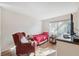 Simple bedroom featuring a twin bed, a chair, and wood floors at 7414 Heather Walk Dr, Weeki Wachee, FL 34613