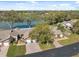 Aerial view of homes with manicured lawns and views of the nearby lake at 7414 Heather Walk Dr, Weeki Wachee, FL 34613