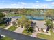 Aerial view of homes with well-maintained lawns and scenic lake views at 7414 Heather Walk Dr, Weeki Wachee, FL 34613