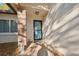 Close up of the front porch featuring brick column and an inviting front door at 7414 Heather Walk Dr, Weeki Wachee, FL 34613