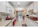 Functional kitchen with white appliances, countertops, and access to the dining area at 7414 Heather Walk Dr, Weeki Wachee, FL 34613