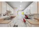 Neat kitchen featuring tiled floors, ample counter space, and white appliances at 7414 Heather Walk Dr, Weeki Wachee, FL 34613