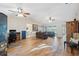 Bright living room with vaulted ceilings, ceiling fans, wood floors, and large windows at 7414 Heather Walk Dr, Weeki Wachee, FL 34613