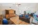 Comfortable living room featuring wood floors, vaulted ceilings, ceiling fans, and comfortable furnishings at 7414 Heather Walk Dr, Weeki Wachee, FL 34613