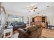 Bright living room with wood floors, a ceiling fan, and a wooden cabinet at 7414 Heather Walk Dr, Weeki Wachee, FL 34613