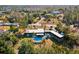 Aerial shot of home featuring a private pool, mature landscaping, and a spacious yard at 7815 Tanglewood Dr, New Port Richey, FL 34654
