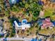 Aerial view of property featuring a private pool, expansive grounds, and mature trees at 7815 Tanglewood Dr, New Port Richey, FL 34654