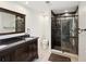 Elegant bathroom with a dark wood vanity, granite countertop and walk-in shower with glass door at 7815 Tanglewood Dr, New Port Richey, FL 34654
