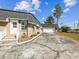 Side view highlighting the house, front door, garage, and driveway at 7815 Tanglewood Dr, New Port Richey, FL 34654