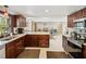 Spacious kitchen with a view of an open floor plan and dark wood cabinetry at 7815 Tanglewood Dr, New Port Richey, FL 34654