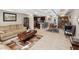 Open-concept living room featuring wood-look tile flooring and comfortable seating at 7815 Tanglewood Dr, New Port Richey, FL 34654