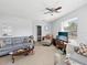 Cozy living room with tile floors, ceiling fan, large windows, and comfortable seating at 7815 Tanglewood Dr, New Port Richey, FL 34654
