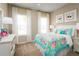 Bright bedroom with colorful bedding, white furniture and large windows with natural light at 10008 Zennia Ln, Parrish, FL 34219