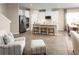 Modern open concept kitchen and dining area with stainless steel appliances and hardwood floors at 10008 Zennia Ln, Parrish, FL 34219