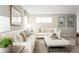 Inviting living room with modern decor, white couches, comfortable seating, and soft neutral colors at 10008 Zennia Ln, Parrish, FL 34219