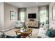 Cozy living room featuring stylish furniture, decor, large windows, and a modern television at 10008 Zennia Ln, Parrish, FL 34219