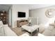 Relaxing loft area with comfortable couches, stylish furniture, and a modern television at 10008 Zennia Ln, Parrish, FL 34219