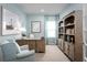 Inviting home office with beautiful blue walls, hardwood furnishings, and soft natural light at 10008 Zennia Ln, Parrish, FL 34219