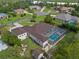 Aerial view of home with screened-in pool, mature landscaping, and long driveway at 10124 Southern Breeze Ct, Weeki Wachee, FL 34613