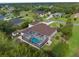 Aerial view showcases backyard with screen enclosed pool and lush landscaping in an established neighborhood at 10124 Southern Breeze Ct, Weeki Wachee, FL 34613