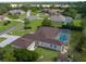 Aerial view showcasing a home with a screen enclosed pool, mature trees, fenced yard, and a small storage shed at 10124 Southern Breeze Ct, Weeki Wachee, FL 34613