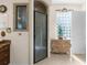 Bathroom view showcasing glass shower, white door and tile floors at 10124 Southern Breeze Ct, Weeki Wachee, FL 34613