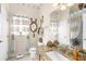 Bathroom featuring decorative mirrors, granite countertops, and decorative curtains on the windows at 10124 Southern Breeze Ct, Weeki Wachee, FL 34613
