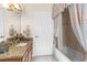 A bathroom with granite countertops, a bath and shower, and decorative accents at 10124 Southern Breeze Ct, Weeki Wachee, FL 34613