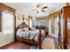 Charming bedroom featuring a four-poster bed, decor and natural light at 10124 Southern Breeze Ct, Weeki Wachee, FL 34613