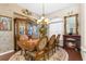 Formal dining room with elegant wood furniture, ornate mirror and chandelier, and charming fireplace at 10124 Southern Breeze Ct, Weeki Wachee, FL 34613