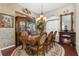 A beautifully decorated dining room with a chandelier, hardwood flooring, and a fireplace at 10124 Southern Breeze Ct, Weeki Wachee, FL 34613