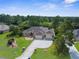 A well-manicured lawn and shrubs accent this spacious, tan home with a three-car garage and decorative stone accents at 10124 Southern Breeze Ct, Weeki Wachee, FL 34613