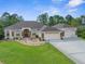 Charming home with stone accents, mature landscaping, and a three-car garage at 10124 Southern Breeze Ct, Weeki Wachee, FL 34613