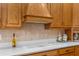 Modern kitchen featuring wood cabinetry, white countertops and backsplash, and stainless appliances at 10124 Southern Breeze Ct, Weeki Wachee, FL 34613