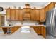 Gourmet kitchen boasts stainless steel appliances, wood cabinets, and stone countertops at 10124 Southern Breeze Ct, Weeki Wachee, FL 34613