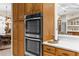 Gourmet kitchen boasts stainless steel double ovens and custom wood cabinetry at 10124 Southern Breeze Ct, Weeki Wachee, FL 34613