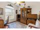 Cozy living room area featuring a hutch with display shelves, a ceiling fan, and a patterned area rug at 10124 Southern Breeze Ct, Weeki Wachee, FL 34613