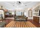Inviting living room boasts wood floors, decorative mirrors, and a view into the adjacent dining room at 10124 Southern Breeze Ct, Weeki Wachee, FL 34613
