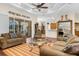 Cozy living room with wood floors, ceiling fan and a view to the outdoor patio at 10124 Southern Breeze Ct, Weeki Wachee, FL 34613