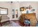 Charming home office with a classic roll-top desk, comfortable chair, and French doors that provide a view into the living room at 10124 Southern Breeze Ct, Weeki Wachee, FL 34613