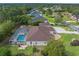 Aerial view of a home with a screened-in pool and lush landscaping at 10124 Southern Breeze Ct, Weeki Wachee, FL 34613