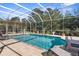 A backyard swimming pool with clear blue water, surrounded by a screen enclosure at 10124 Southern Breeze Ct, Weeki Wachee, FL 34613