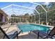 Relaxing screened-in pool area with lounge chairs and decorative fountains at 10124 Southern Breeze Ct, Weeki Wachee, FL 34613