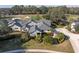 Stunning single-story home featuring mature landscaping, a paved driveway, and views of the lush green golf course at 2595 Royal Liverpool Dr, Tarpon Springs, FL 34688