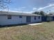 Backyard view showcasing a concrete patio and lush green space at 3421 Allandale Dr, Holiday, FL 34691